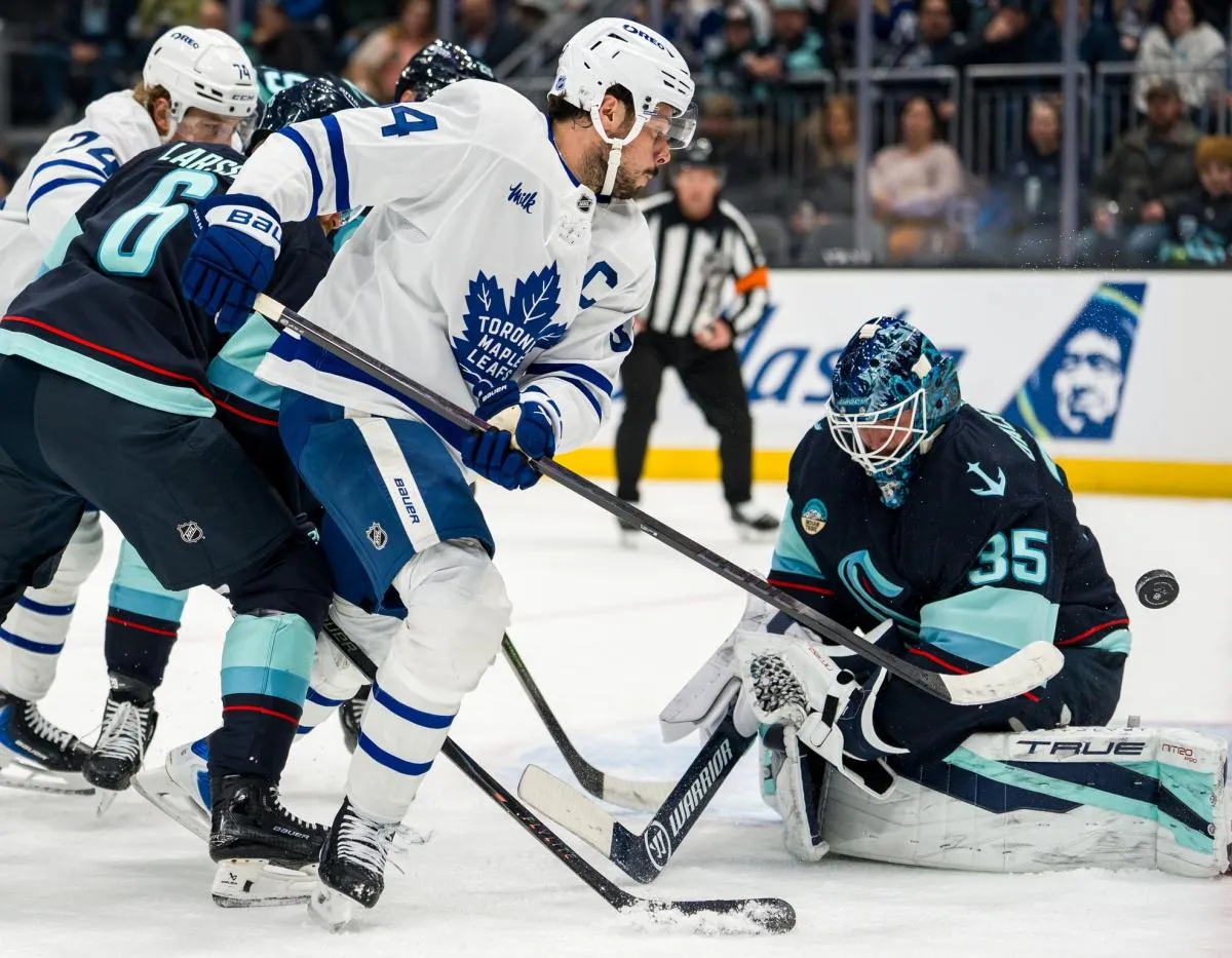 Toronto Maple Leafs forward Auston Matthews (34), second from right, takes a shot against Seattle Kraken goalie Joey Daccord (35) during the first period at Climate Pledge Arena.