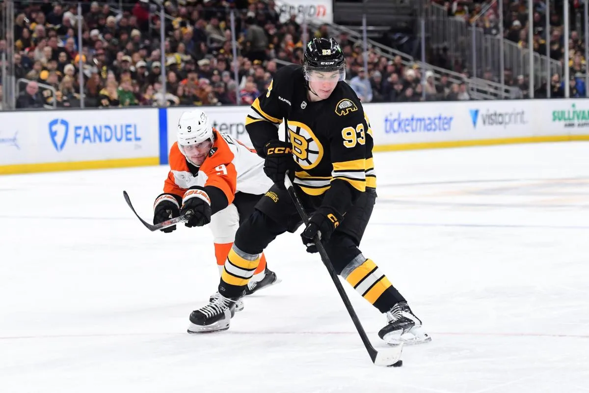Boston Bruins center Fraser Minten (93) controls the puck from Philadelphia Flyers defenseman Jamie Drysdale (9) during the third period at TD Garden.