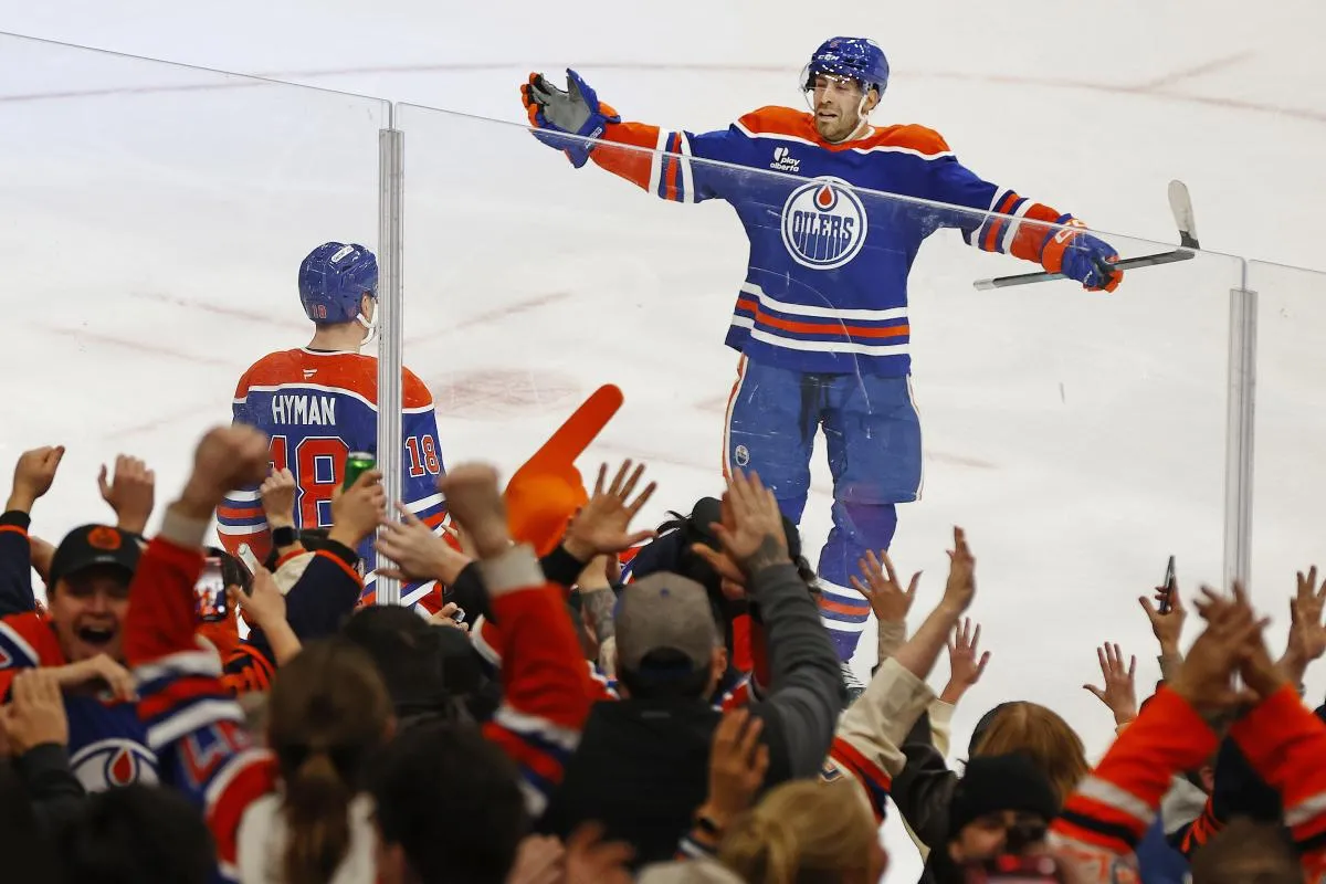 Edmonton Oilers forward Zach Hyman (18) and defensemen Evan Bouchard (2) celebrate after scoring a goal during overtime against the San Jose Sharks at Rogers Place.