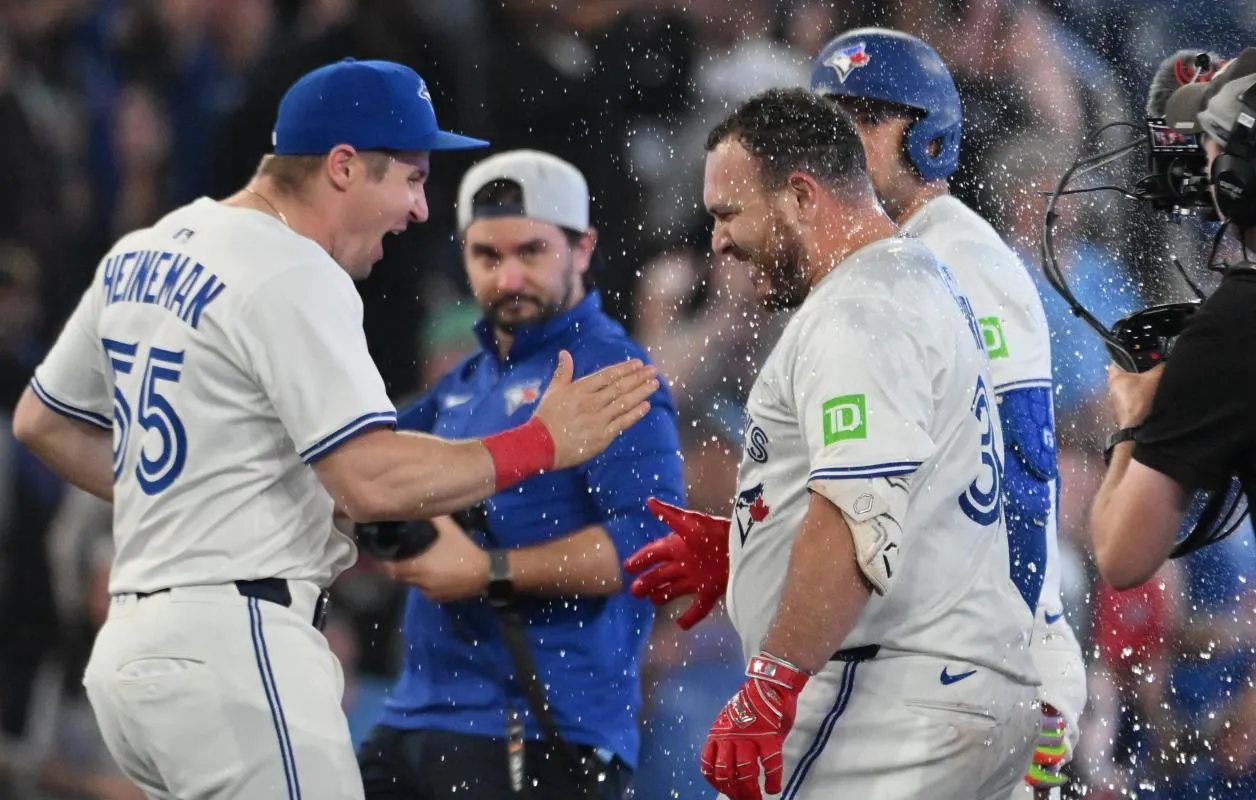 Toronto Blue Jays catcher Alejandro Kirk (30) is greeted by catcher Tyler Heineman (55) after hitting a walkoff RBI double against the Philadelphia Phillies in the ninth inning at Rogers Centre.