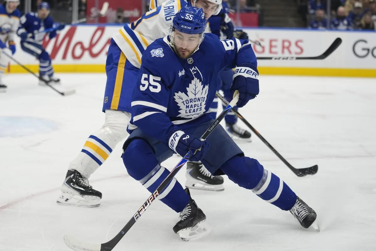 Toronto Maple Leafs forward Nick Roy (55) tries to control the puck against Buffalo Sabres defenseman Michael Kesselring (8) during the first period at Scotiabank Arena.