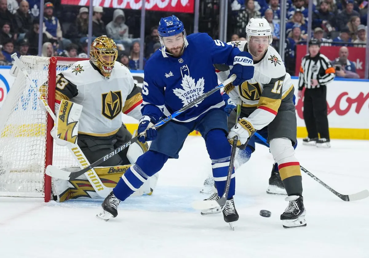 Toronto Maple Leafs center Nicolas Roy (55) battles for the puck with Vegas Golden Knights defenseman Ben Hutton (17) during the third period at Scotiabank Arena.