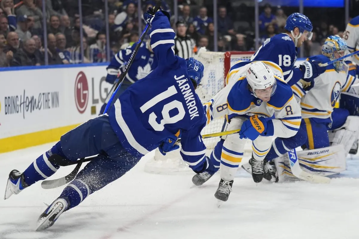 Buffalo Sabres defenseman Michael Kesselring (8) trips up Toronto Maple Leafs forward Calle Jarnkrok (19) during the third period at Scotiabank Arena.