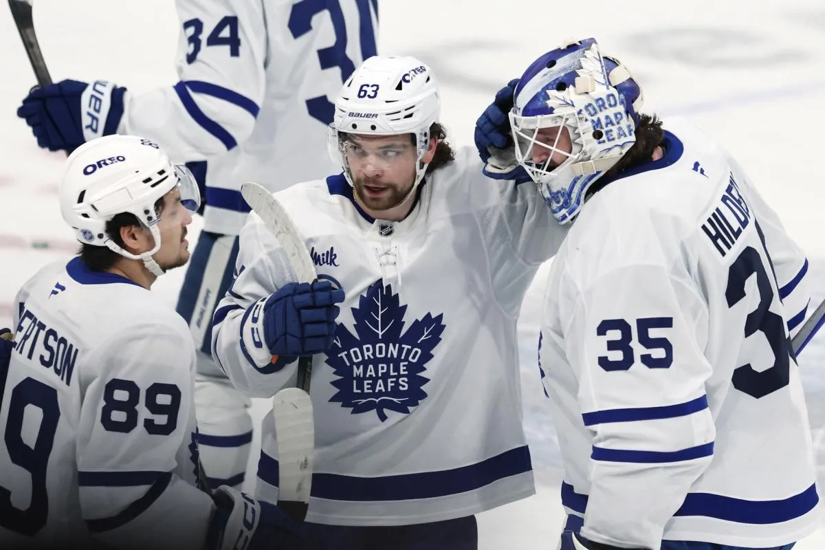 Toronto Maple Leafs left wing Nicholas Robertson (89), Matias MacCelli (63) and goaltender Dennis Hildeby (35) celebrate their victory over the Winnipeg Jets at Canada Life Centre.