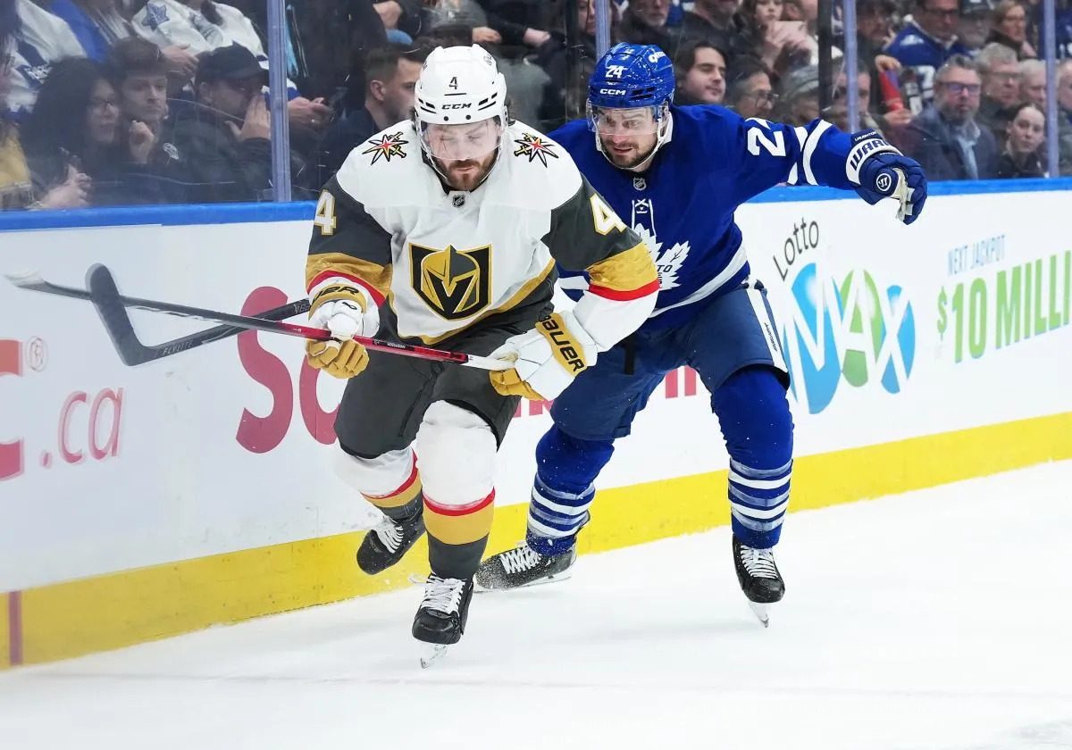 Toronto Maple Leafs center Scott Laughton (24) battles along the boards with Vegas Golden Knights defence man Rasmus Andersson (4) during the first period at Scotiabank Arena.