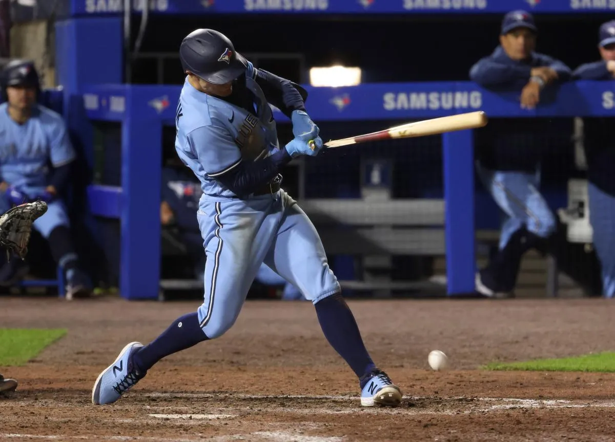 Toronto Blue Jays center fielder Randal Grichuk (15) breaks his bat on a base hit during the eighth inning against the New York Yankees at Sahlen Field.