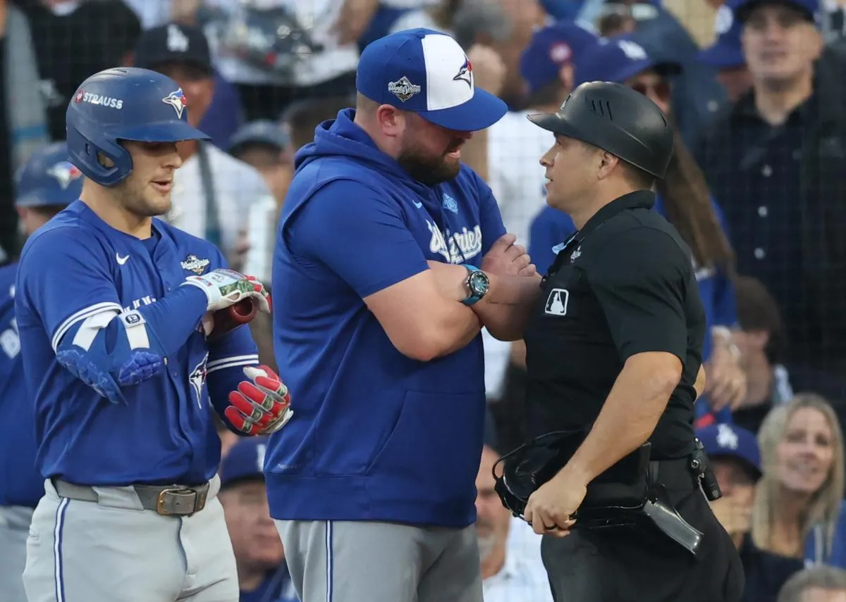 Toronto Blue Jays manager John Schneider (14) talks to home plate umpire Mark Wegner during the second inning against the Los Angeles Dodgers in game three of the 2025 MLB World Series at Dodger Stadium.