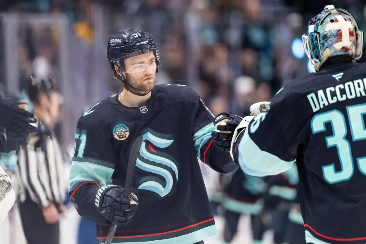 Seattle Kraken forward Shane Wright (51) celebrates a goal wiht Seattle Kraken goalie Joey Daccord (35) during the third period against the Toronto Maple Leafs at Climate Pledge Arena.
