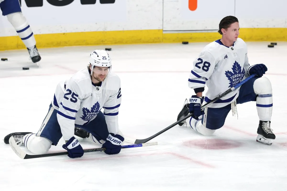 Toronto Maple Leafs defenseman Brandon Carlo (25) and Toronto Maple Leafs defenseman Troy Stecher (28) warm up before a game against the Winnipeg Jets at Canada Life Centre.