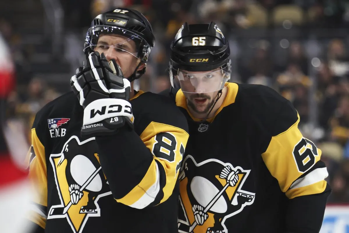 Pittsburgh Penguins center Sidney Crosby (87) and defenseman Erik Karlsson (65) talk before a face-off against the Ottawa Senators during the third period at PPG Paints Arena.