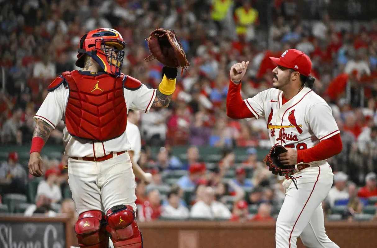 St. Louis Cardinals catcher Yadier Molina (4) celebrates with relief pitcher JoJo Romero (59) after the eighth inning against the Chicago Cubs at Busch Stadium.