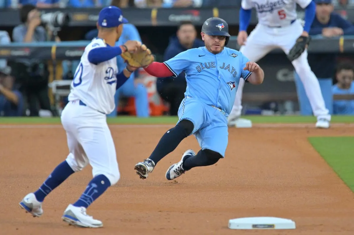 Toronto Blue Jays catcher Alejandro Kirk (30) is out at second base against Los Angeles Dodgers shortstop Mookie Betts (50) in the first inning during game five of the 2025 MLB World Series at Dodger Stadium.