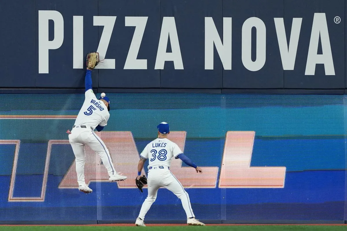 Toronto Blue Jays center fielder Daulton Varsho (5) attempts to make a catch against the Los Angeles Dodgers in the fourth inning for game seven of the 2025 MLB World Series at Rogers Centre.