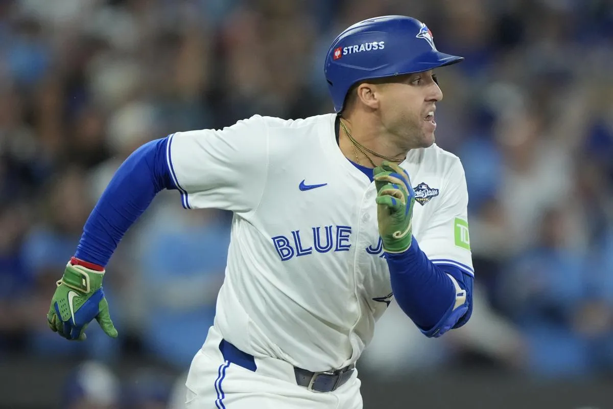 Toronto Blue Jays right fielder George Springer (4) runs after hitting a single against the Los Angeles Dodgers in the first inning during game seven of the 2025 MLB World Series at Rogers Centre.