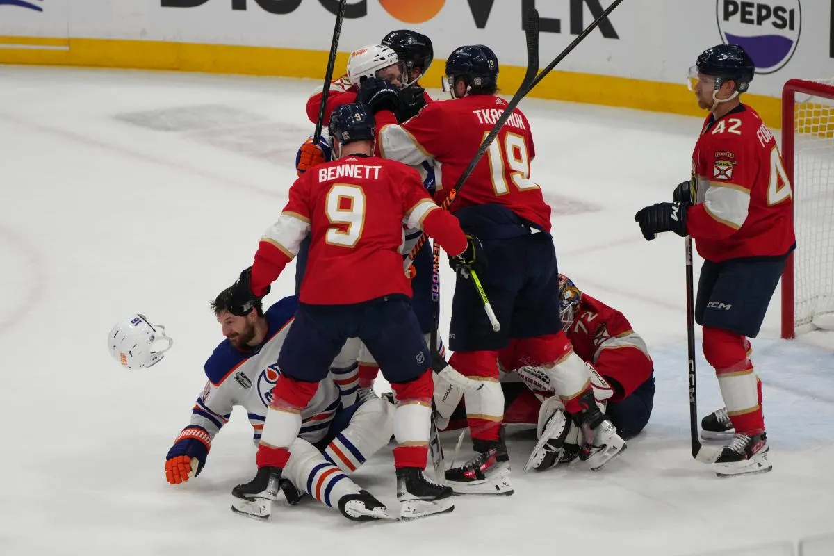 a fight breaks out after Edmonton Oilers forward Zach Hyman (18) is checked into Florida Panthers goaltender Sergei Bobrovsky (72) by forward Sam Bennett (9) during the first period in game one of the 2024 Stanley Cup Final at Amerant Bank Arena.
