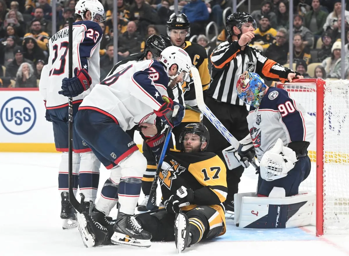 Pittsburgh Penguins right wing Bryan Rust (17) gets tangled up with Columbus Blue Jackets center Boone Jenner (38) during the third period at PPG Paints Arena. Columbus won 4-3 in a shoot out.