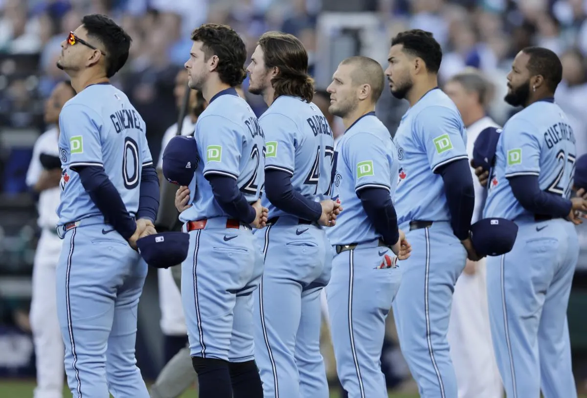 Toronto Blue Jays players line up before game three of the ALCS round for the 2025 MLB playoffs against the Seattle Mariners at T-Mobile Park.