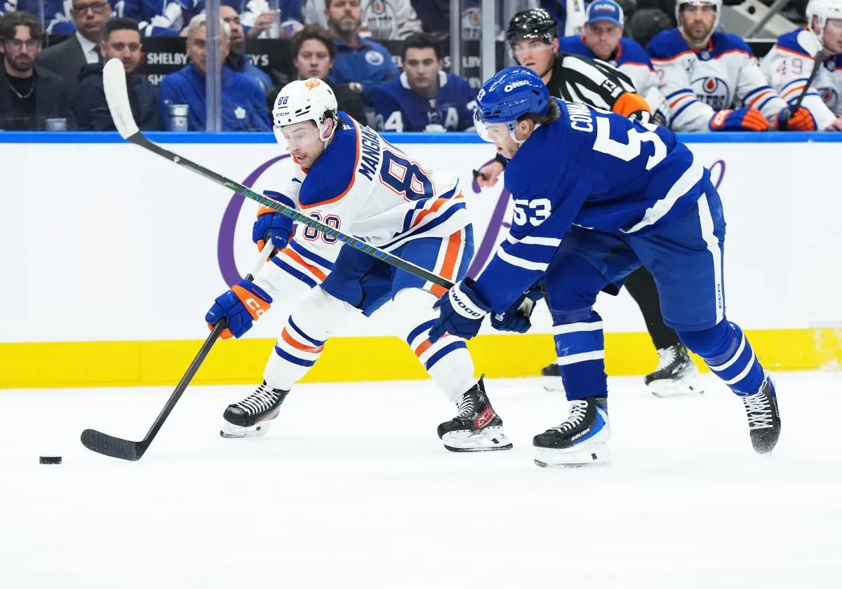 Edmonton Oilers left wing Andrew Mangiapane (88) battles for the puck with Toronto Maple Leafs right wing Easton Cowan (53) during the first period at Scotiabank Arena.