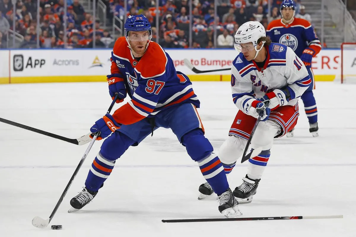 Edmonton Oilers forward Connor McDavid (97) looks to make a pass in front of New York Rangers forward Artemi Panarin (10) during the first period at Rogers Place.
