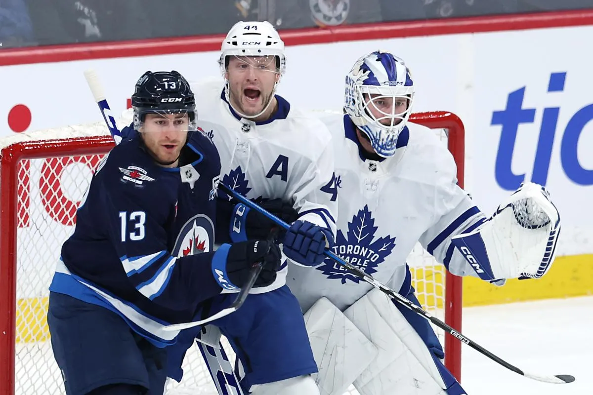 Winnipeg Jets center Gabriel Vilardi (13), Toronto Maple Leafs defenseman Morgan Rielly (44) and Toronto Maple Leafs goaltender Dennis Hildeby (35) watch the play develop in the first period at Canada Life Centre.