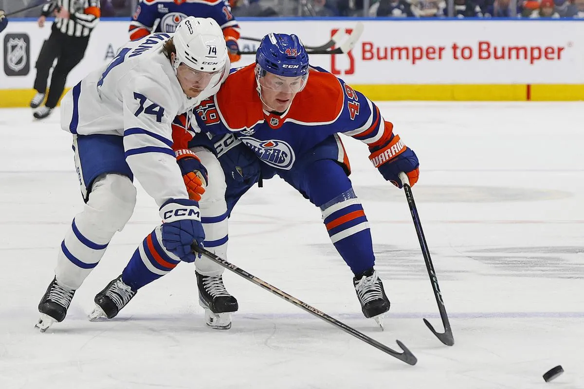 Toronto Maple Leafs forward Bobby McMann (74) and Edmonton Oilers defensemen Ty Emberson (49) chases a loose puck during the second period at Rogers Place