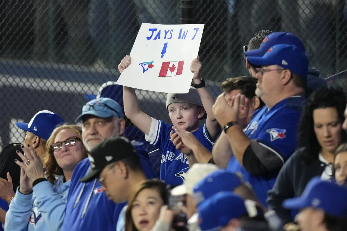 A fan holds up a sign to support the Toronto Blue Jays before game seven of the 2025 MLB World Series against the Los Angeles Dodgers at Rogers Centre.