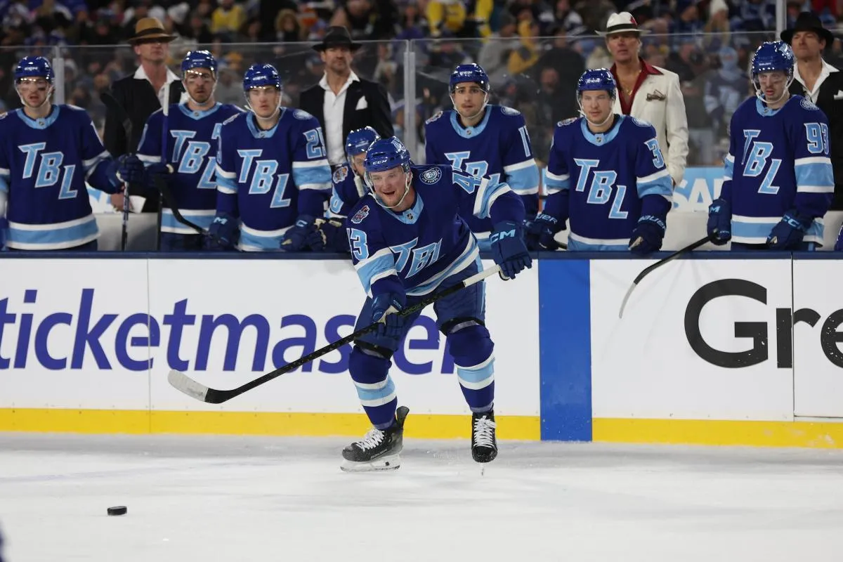 Tampa Bay Lightning defenseman Darren Raddysh (43) looks to controls the loose puck against the Boston Bruins during the second period in the 2026 Stadium Series ice hockey game at Raymond James Stadium