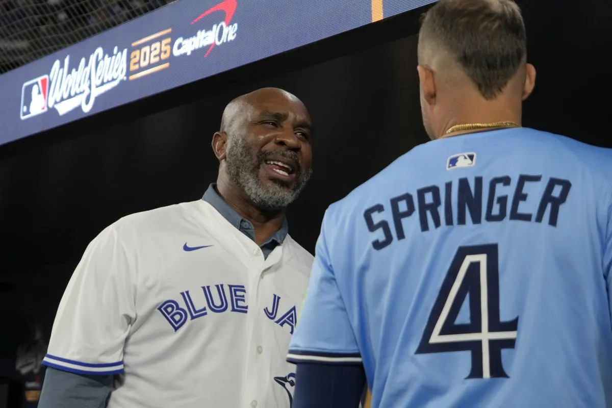 Toronto Blue Jays former player Devon White talks with right fielder George Springer (4) in the dugout before game six of the 2025 MLB World Series against the Los Angeles Dodgers 1at Rogers Centre.