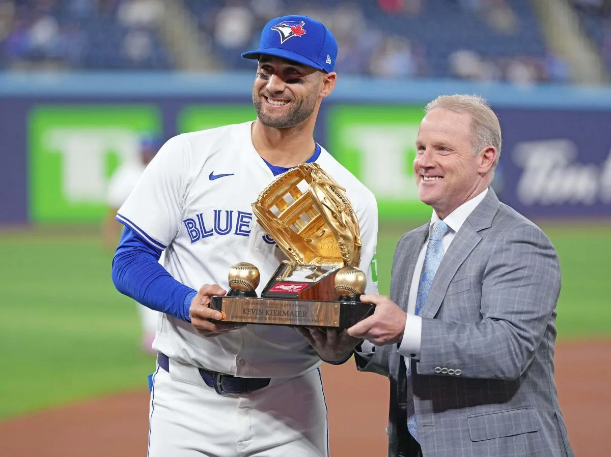 A representative from Rawlings Canada presents Toronto Blue Jays centre fielder Kevin Kiermaier (39) with a Golden Glove award before a game against the Colorado Rockies at Rogers Centre.