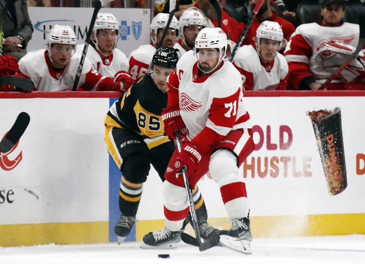 Detroit Red Wings center Dylan Larkin (71) moves the puck against Pittsburgh Penguins right wing Avery Hayes (85) during the third period at PPG Paints Arena. Detroit won 2-1.