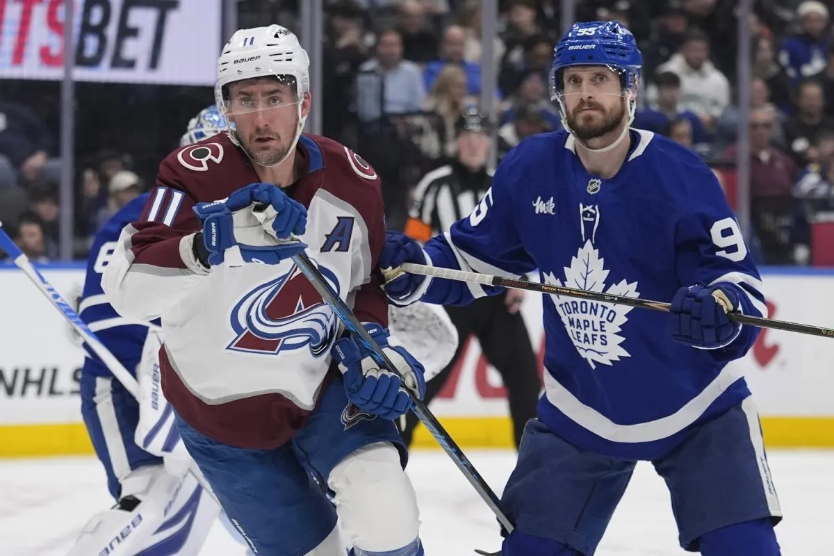 Colorado Avalanche forward Brock Nelson (11) and Toronto Maple Leafs defenseman Oliver Ekman-Larsson (95) look for the puck during the second period at Scotiabank Arena.