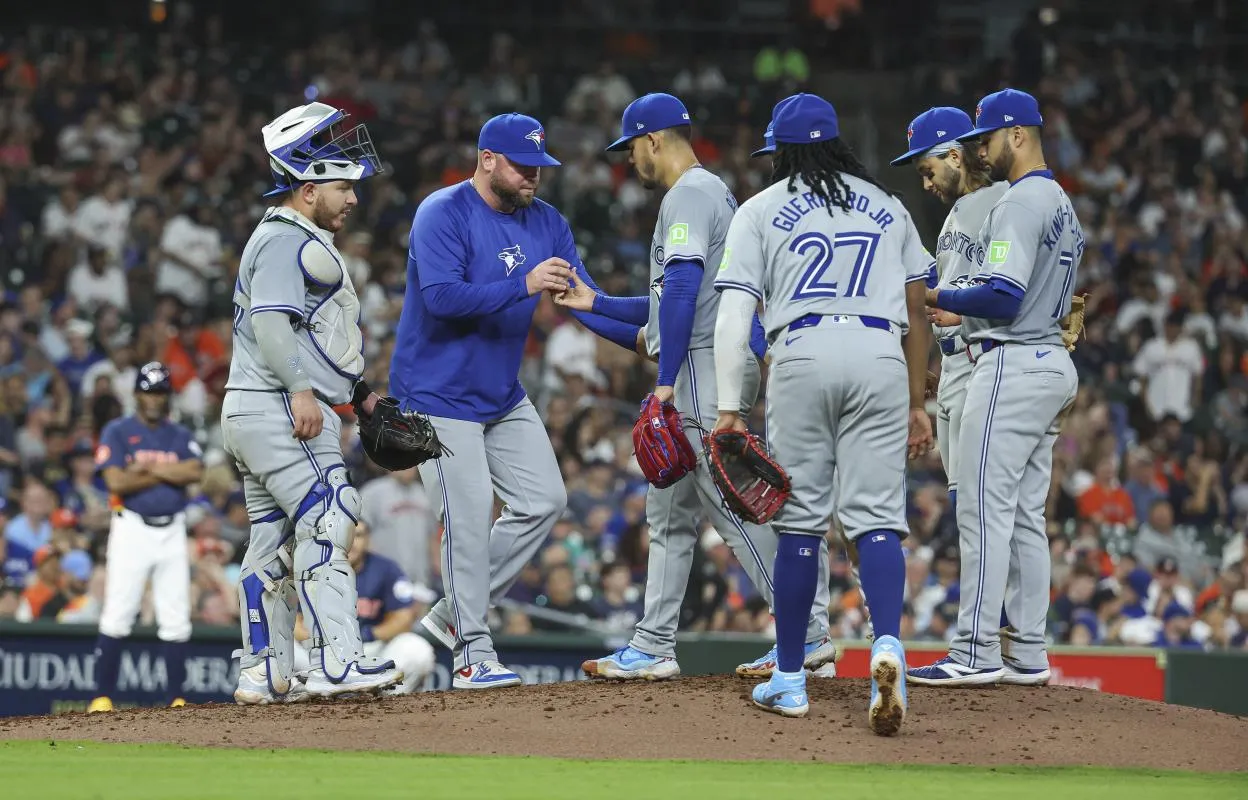 Toronto Blue Jays starting pitcher Jose Berrios (17) hands the ball to manager John Schneider during a pitching change in the seventh inning against the Houston Astros at Minute Maid Park.