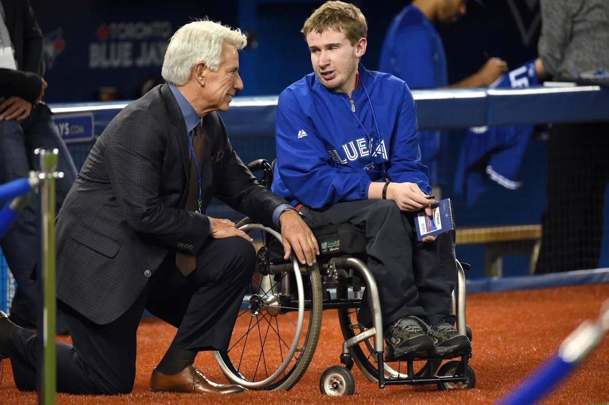 Toronto Blue Jays former catcher and now broadcaster Buck Martinez (left) chats with a fan prior to the Blue Jays game against Baltimore Orioles at Rogers Centre.