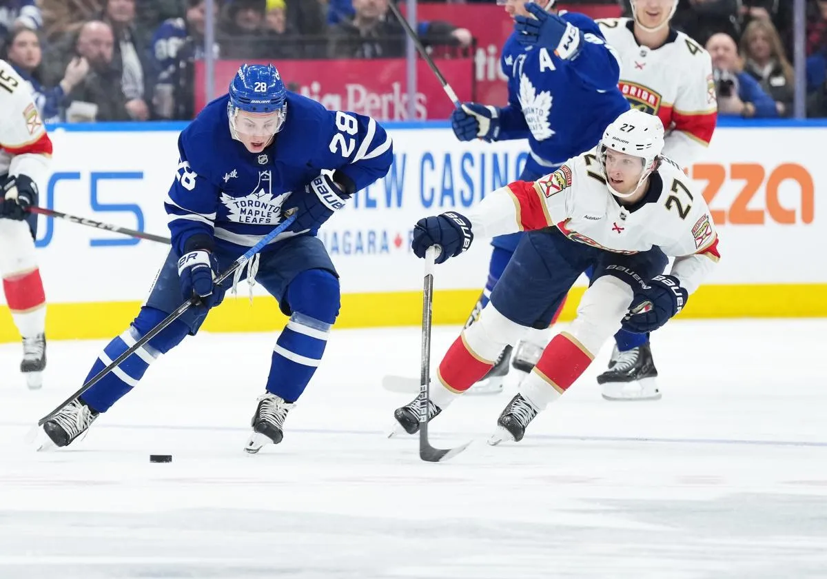 Toronto Maple Leafs defenseman Troy Stecher (28) battles for the puck with Florida Panthers center Eetu Luostarinen (27) during the second period at Scotiabank Arena