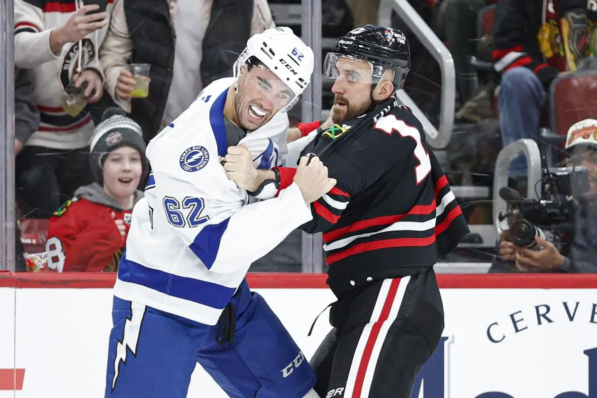 Chicago Blackhawks left wing Nick Foligno (17) fights with Tampa Bay Lightning center Jack Finley (62) during the first period at United Center.