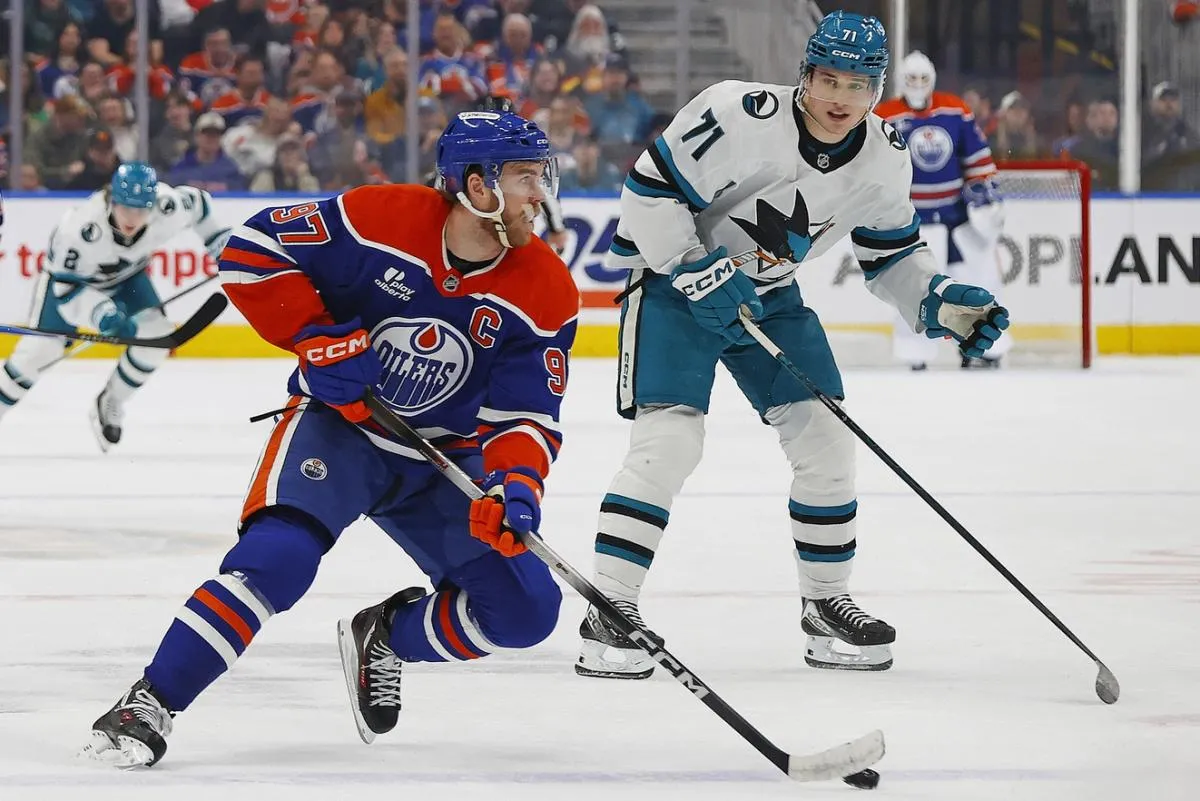 Edmonton Oilers forward Connor McDavid (97) looks to make a pass in front of San Jose Sharks forward Macklin Celebrini (71) during the first period at Rogers Place.