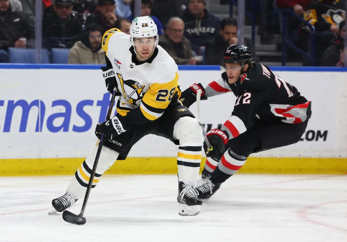 Pittsburgh Penguins defenseman Parker Wotherspoon (28) clears the puck as Buffalo Sabres center Tage Thompson (72) defends during the second period at KeyBank Center.
