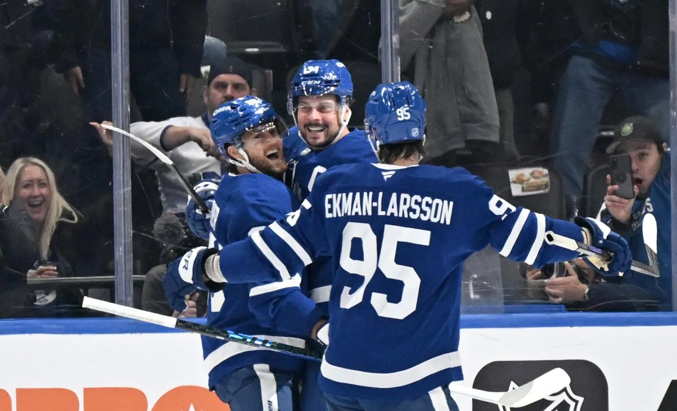 Toronto Maple Leafs forward Auston Matthews (34) celebrates with forward William Nylander (88) and defenseman Oliver Ekman-Larsson (95) after scoring the winning goal against the New York Rangers in overtime at Scotiabank Arena