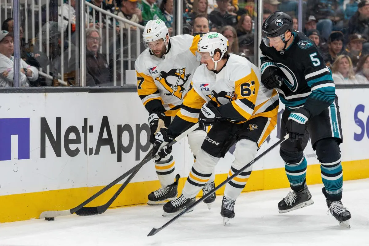 San Jose Sharks defenseman Vincent Desharnais (5) and Pittsburgh Penguins right wing Rickard Rakell (67) battle for the puck during first perioid at SAP Center at San Jose.
