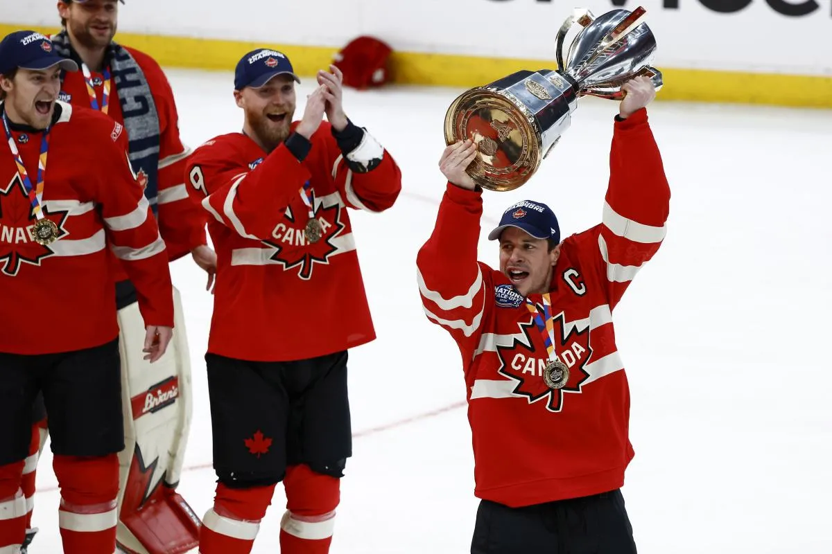 [Imagn Images direct customers only] Team Canada forward Sydney Crosby (87) lifts the trophy after defeating the United States during the 4 Nations Face-Off ice hockey championship game at TD Garden.