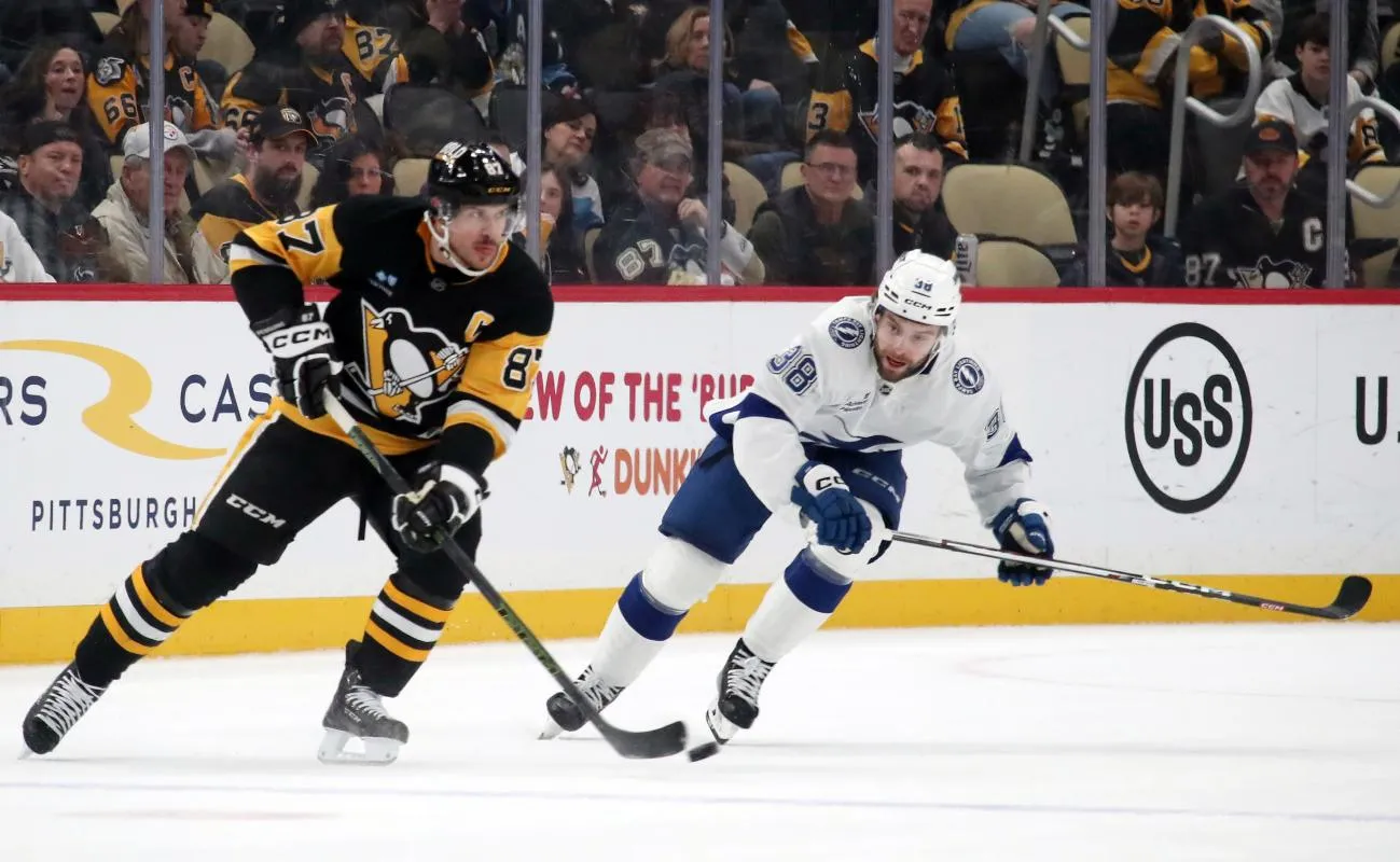 Pittsburgh Penguins center Sidney Crosby (87) handles the puck against Tampa Bay Lightning left wing Brandon Hagel (38) during the first period at PPG Paints Arena.