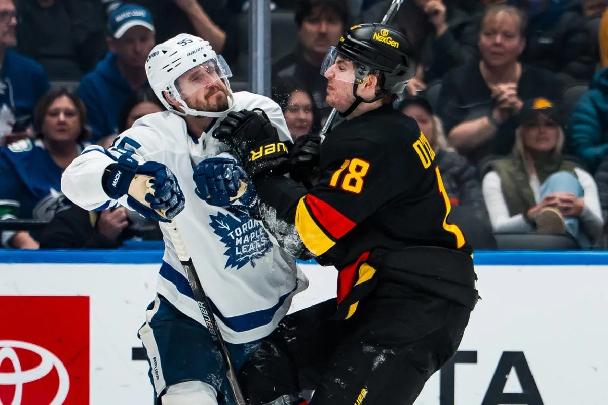 Vancouver Canucks forward Drew O'Connor (18) collides with Toronto Maple Leafs defenseman Oliver Ekman-Larsson (95) in overtime at Rogers Arena.
