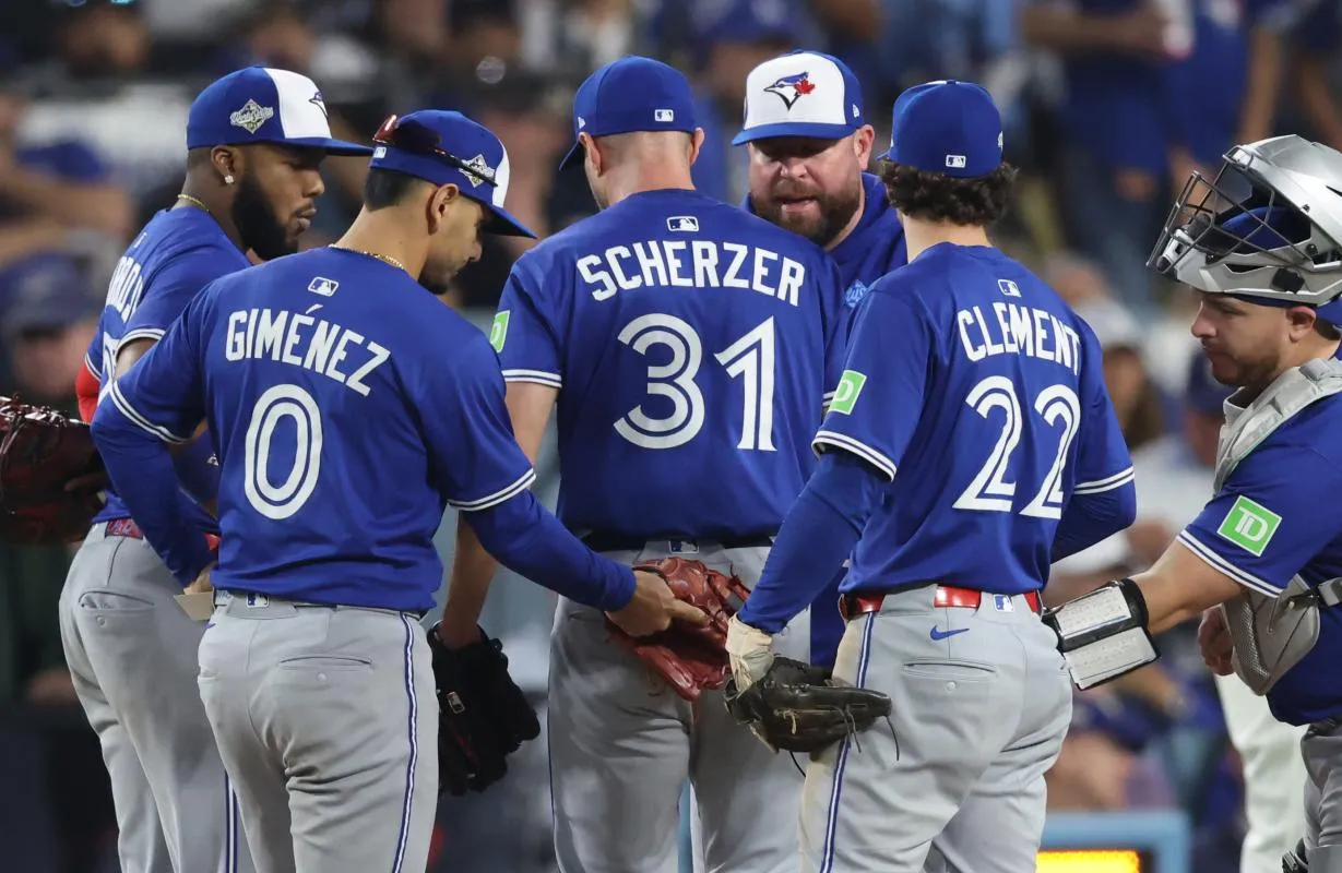 Toronto Blue Jays manager John Schneider (14) relieves pitcher Max Scherzer (31) during the fifth inning against the Los Angeles Dodgers in game three of the 2025 MLB World Series at Dodger Stadium.