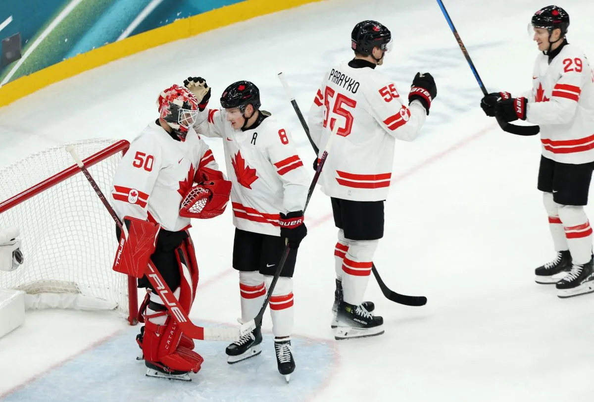 Jordan Binnington of Canada celebrates with teammates after defeating Czechia in a men's ice hockey Group A match during the Milano Cortina 2026 Olympic Winter Games at Milano Santagiulia Ice Hockey Arena.