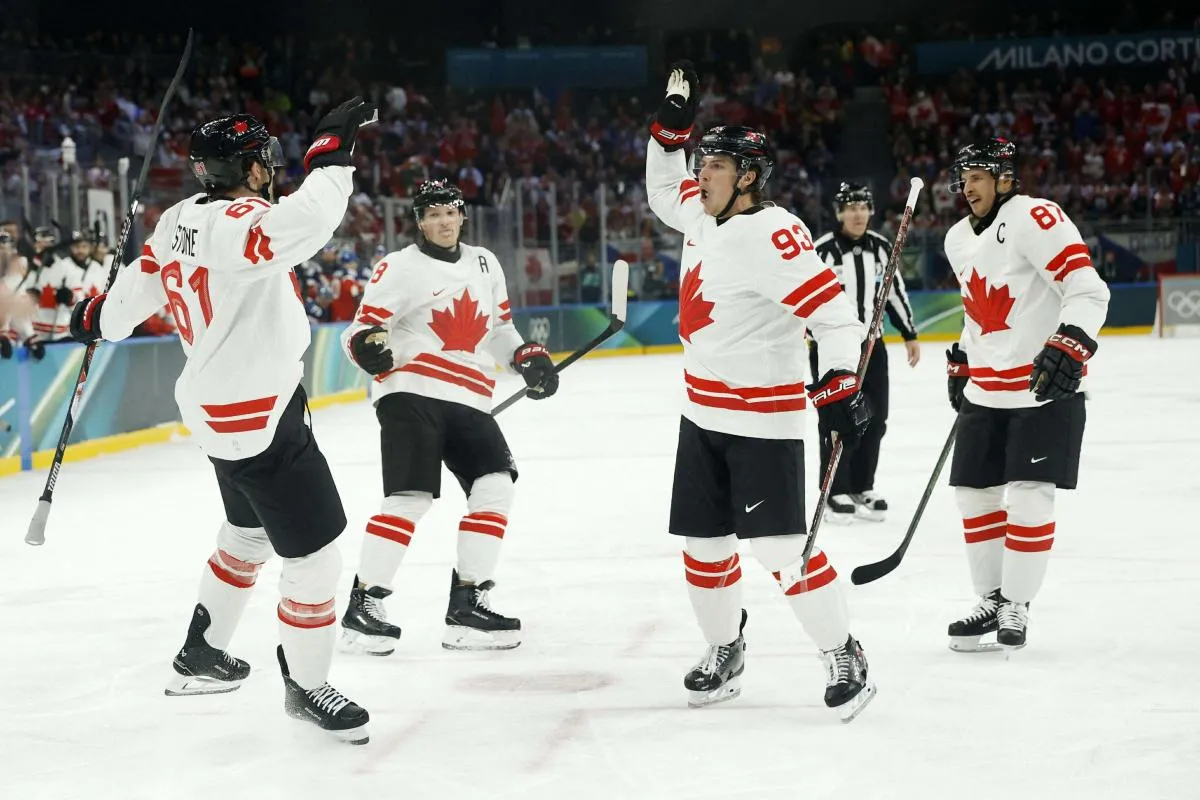 Mark Stone of Canada celebrates scoring their second goal with Mitch Marner of Canada against Czechia in a men's ice hockey group A match during the Milano Cortina 2026 Olympic Winter Games at Milano Santagiulia Ice Hockey Arena.
