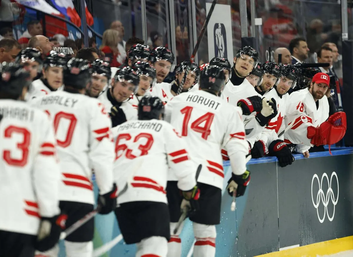 Bo Horvat of Canada celebrates scoring their third goal with teammates against Czechia in a men's ice hockey group A match during the Milano Cortina 2026 Olympic Winter Games at Milano Santagiulia Ice Hockey Arena.