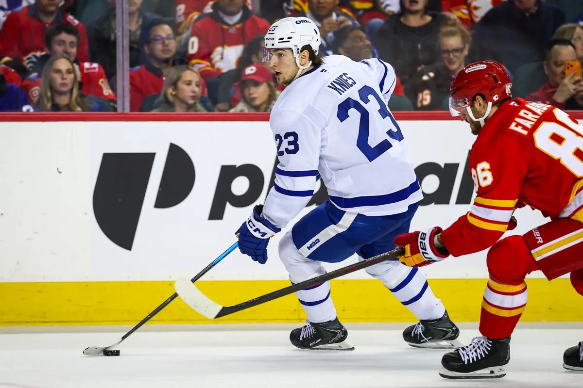Toronto Maple Leafs left wing Matthew Knies (23) controls the puck against Calgary Flames left wing Joel Farabee (86) during the third period at Scotiabank Saddledome.