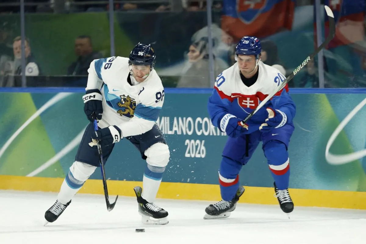 Mikko Rantanen of Finland in action with Juraj Slafkovsky of Slovakia in men's ice hockey group B play during the Milano Cortina 2026 Olympic Winter Games at Milano Santagiulia Ice Hockey Arena.