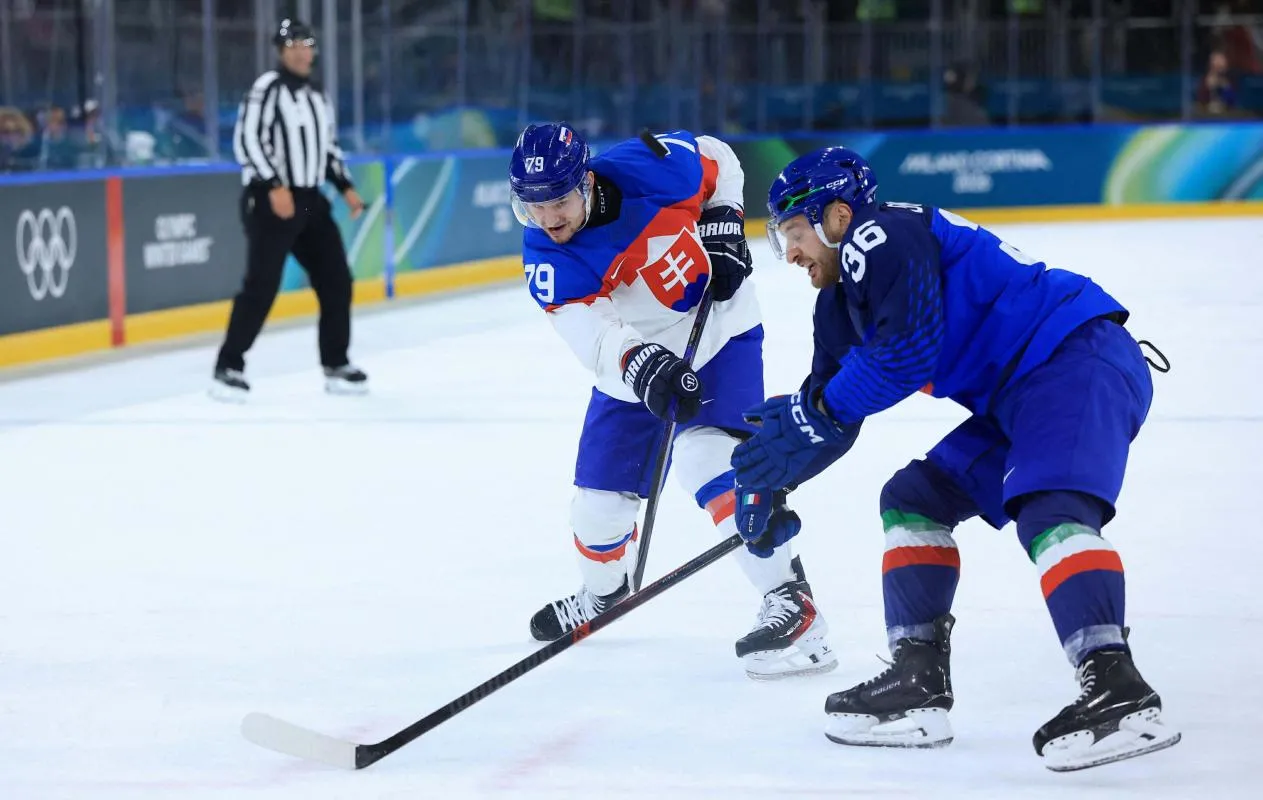 Libor Hudacek of Slovakia in action with Cristiano Digiacinto of Italy during a Group B men's ice hockey game during the Milano Cortina 2026 Olympic Winter Games at Milano Rho Ice Hockey Arena
