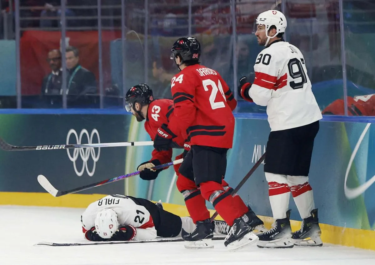 Kevin Fiala of Switzerland sustains an injury against Canada in men's ice hockey group A play during the Milano Cortina 2026 Olympic Winter Games at Milano Santagiulia Ice Hockey Arena.